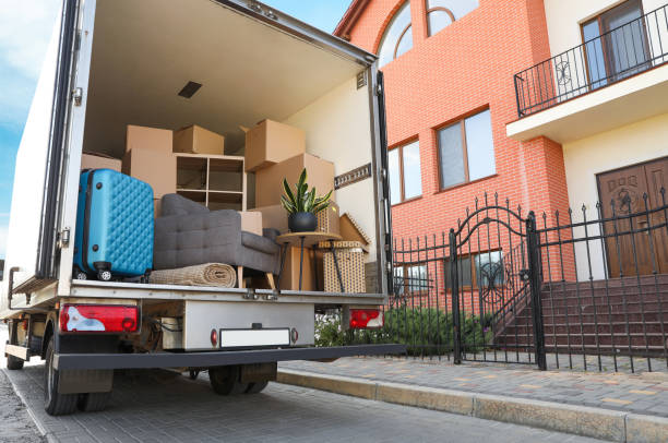 Van full of moving boxes and furniture near house Van full of moving boxes and furniture near house